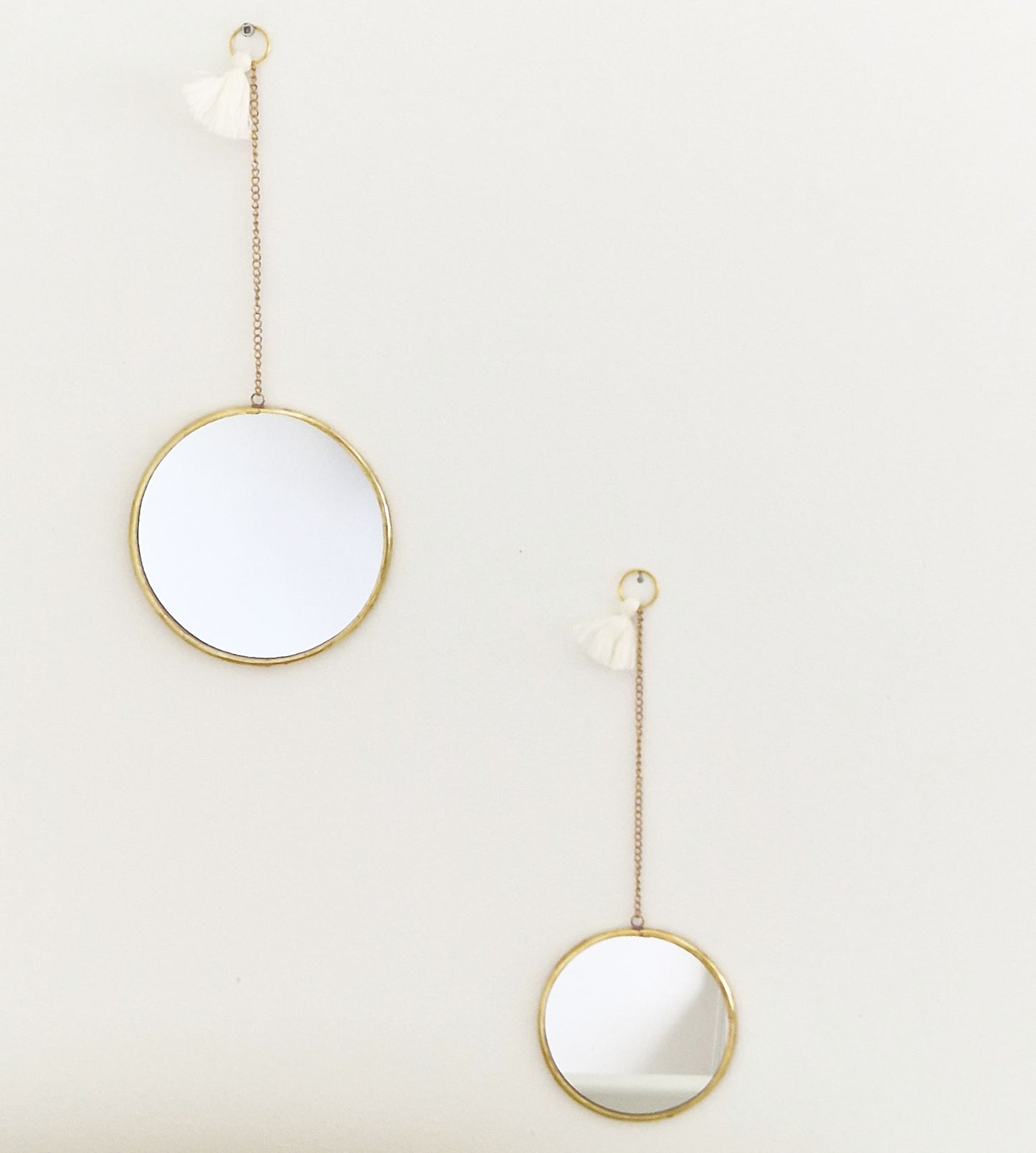 Set of 2 round brass mirrors on chain with tassel