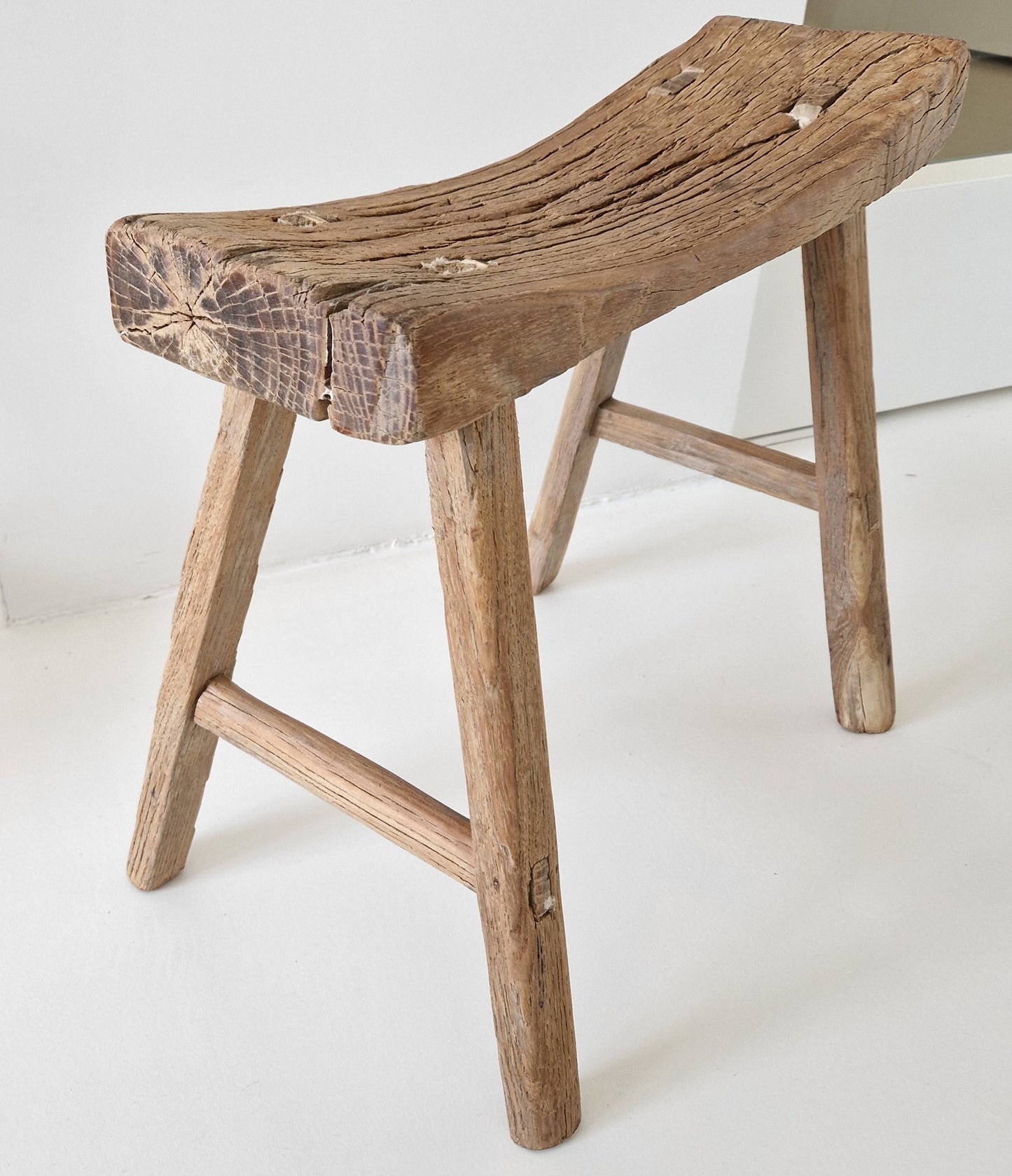 Old wooden saddle stool
