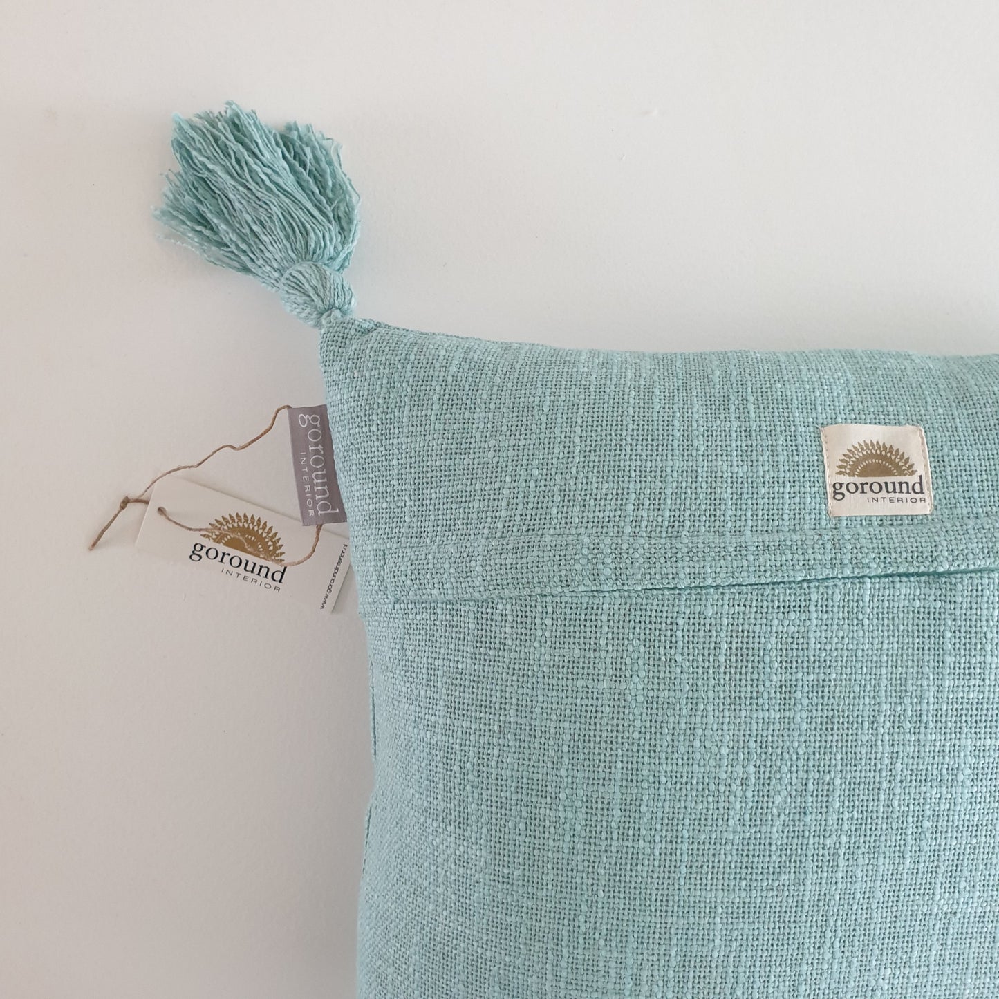 Turquoise cushion with tassels